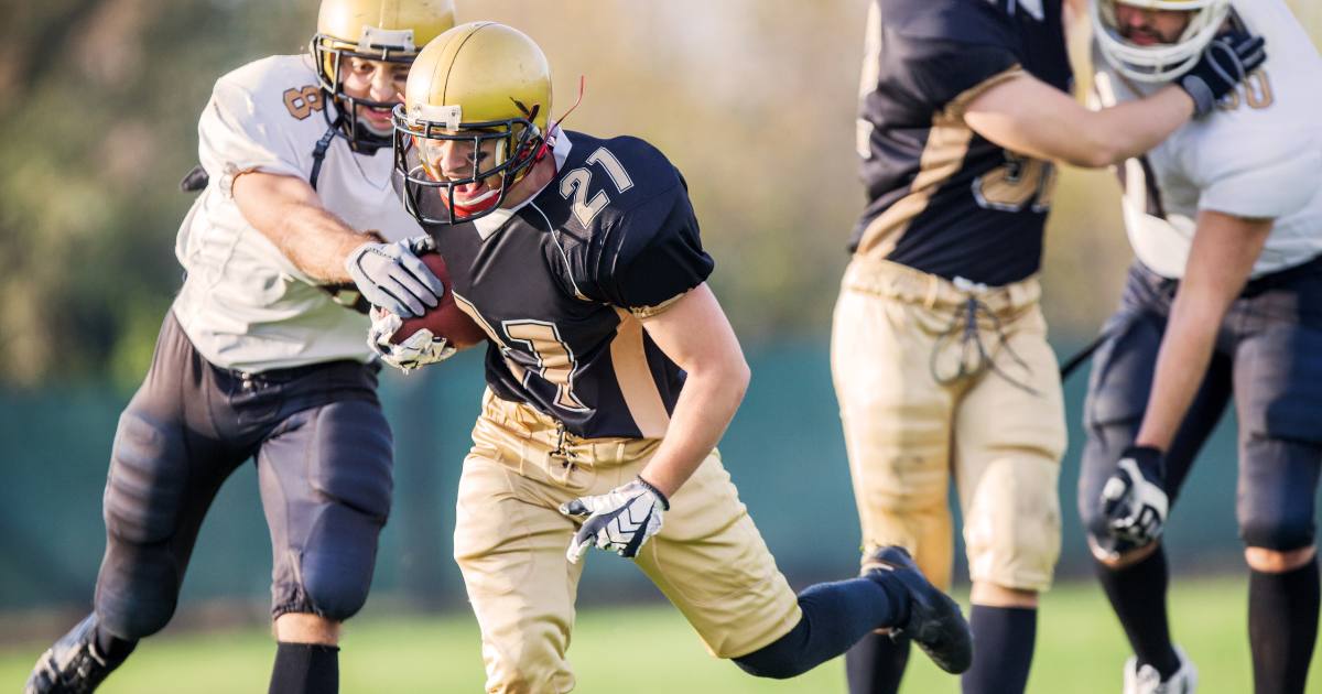 College athletes playing football after eating high-protein snacks